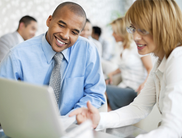 Photo of a financial professional and client looking at a computer screen